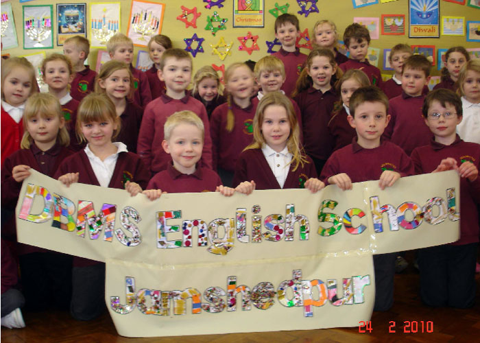Friends from Denbydale, England holding our school banner.